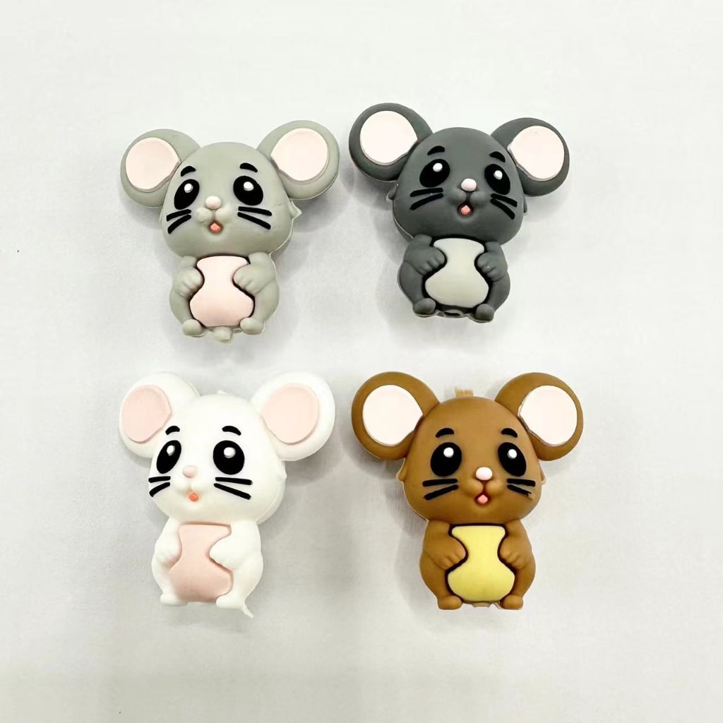A collection of silicone beads in the shape of cute mouse rats in various colors including gray, black, white, and brown.