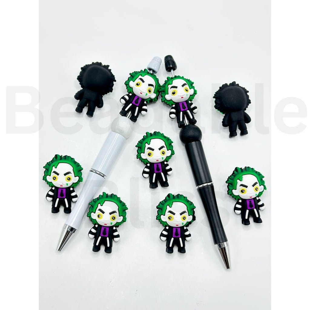 Two pens with Joker-themed pen toppers on a white background