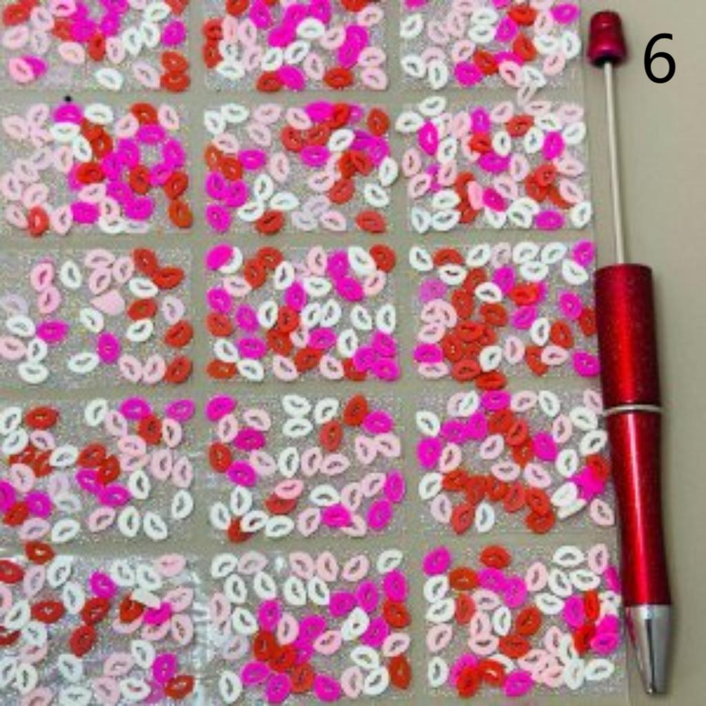 Colorful sequin pattern with a red pen on a gray background