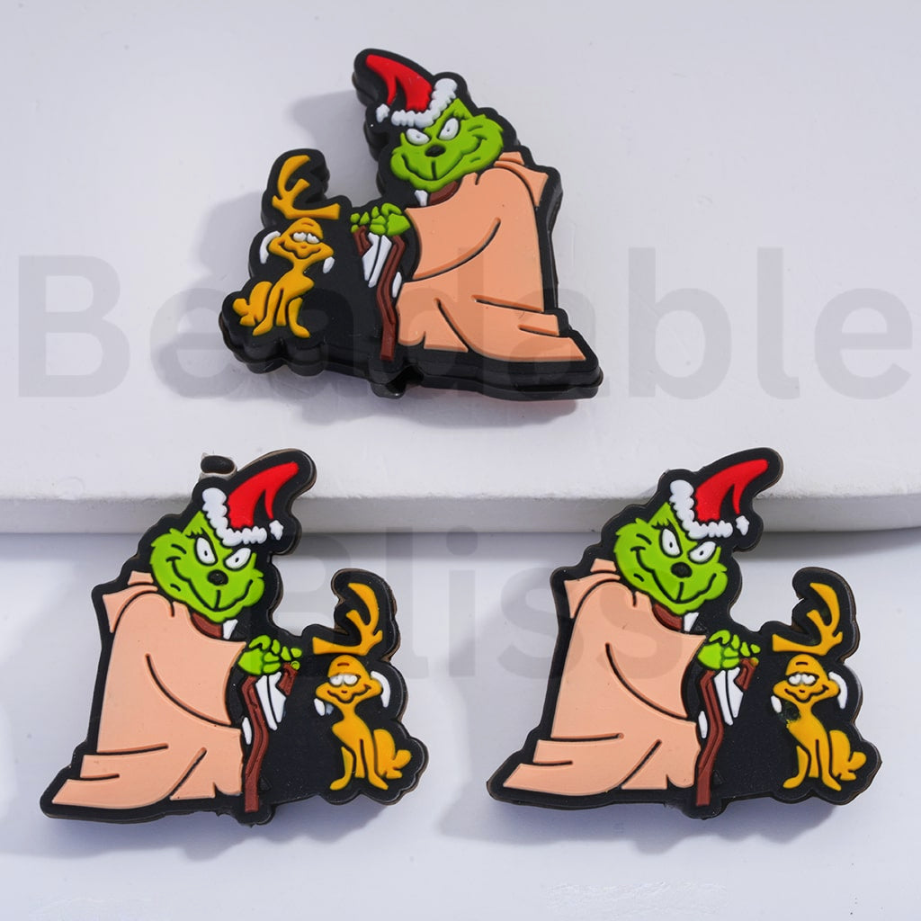 Two Christmas-themed pins featuring a cartoon character and a dog on a white background.