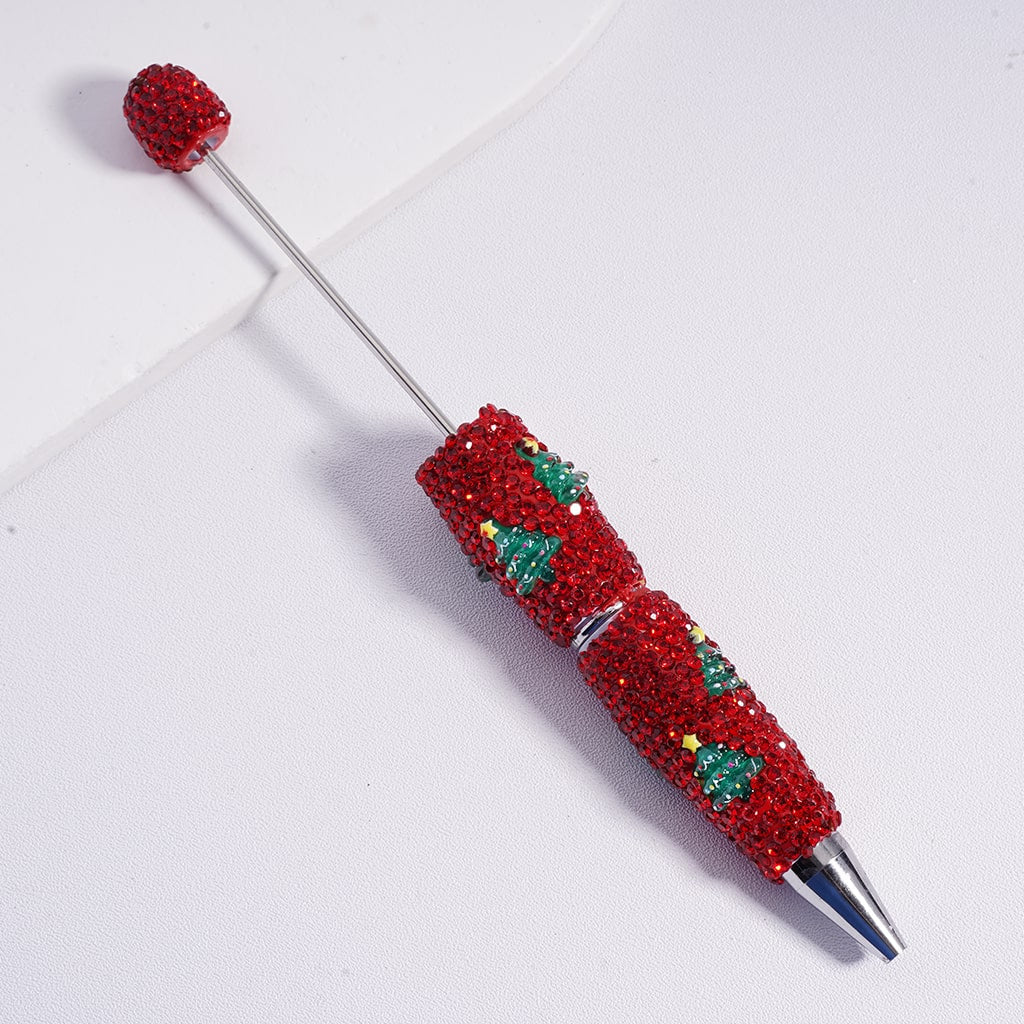 Decorative pen with red gemstones and festive design on a white background