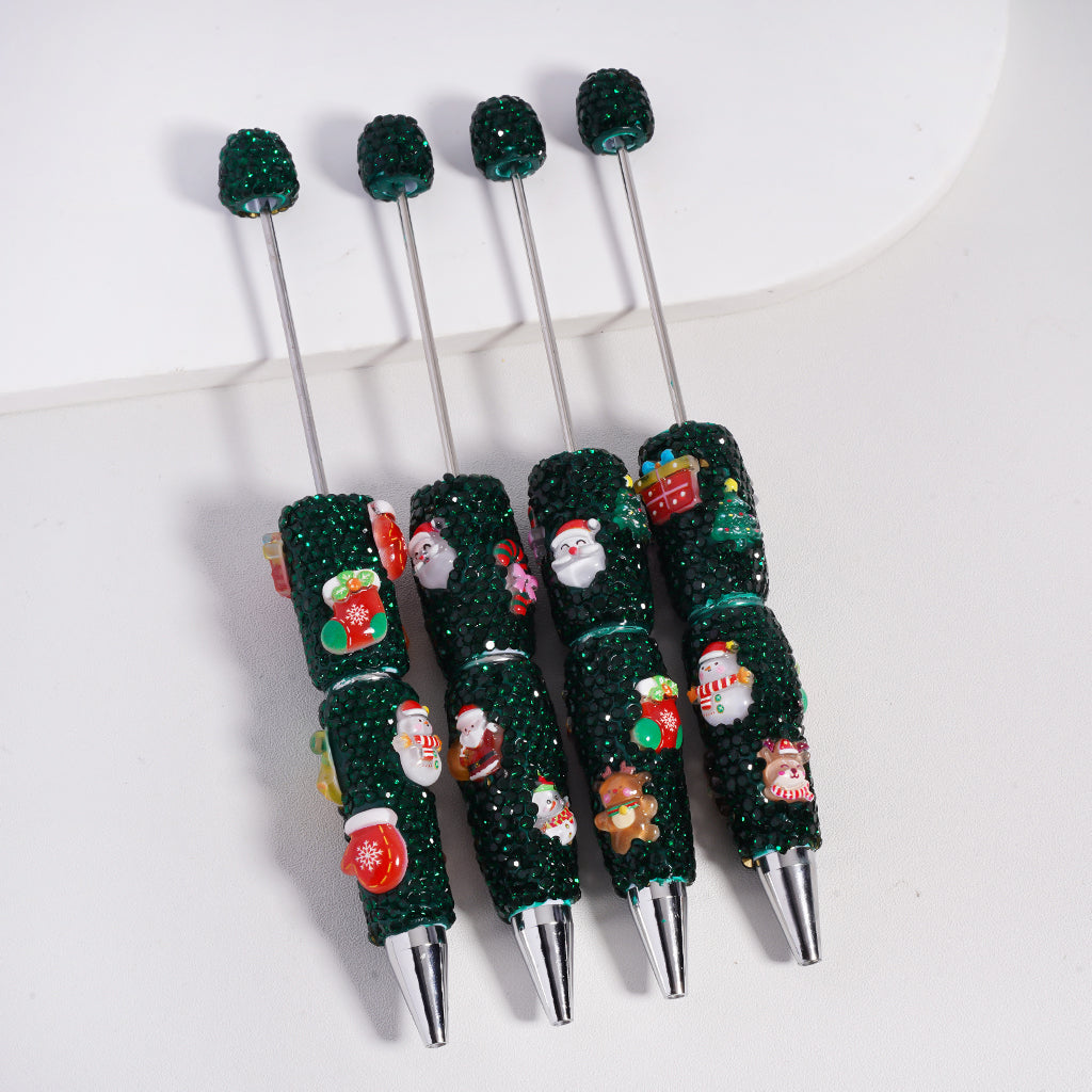 Decorative pen with green textured grip and floral patterns on a white background