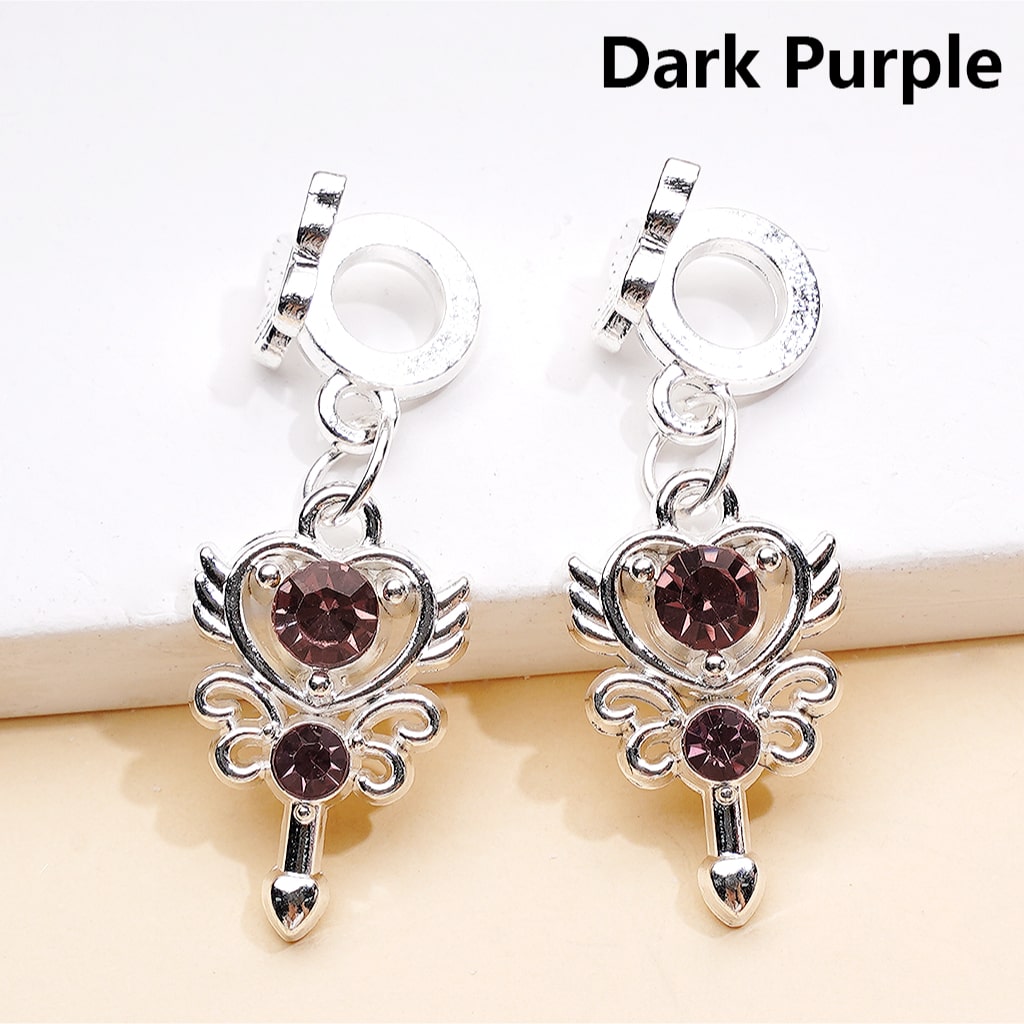 Dark purple heart-shaped earrings with silver accents on a white background
