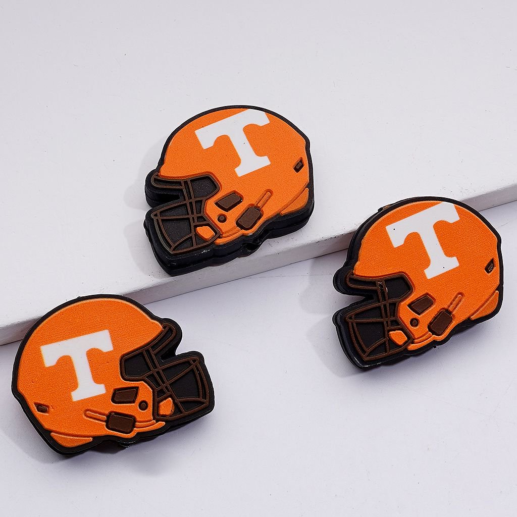 Three orange helmets with a white 'T' on a light gray background