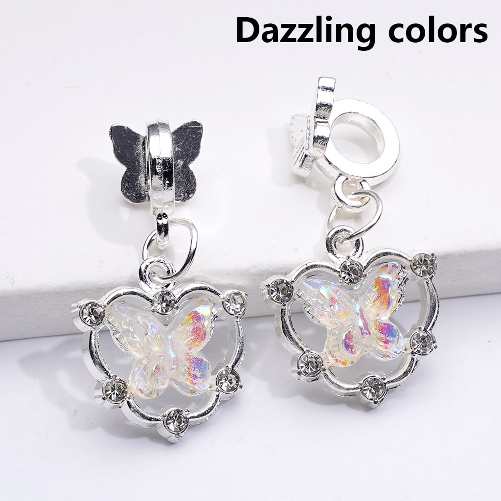 Butterfly-shaped earrings with iridescent centers on a white background