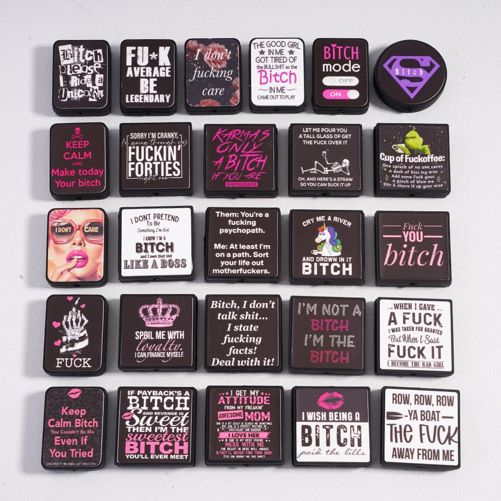 Collection of small rectangular containers with various printed phrases on a white background