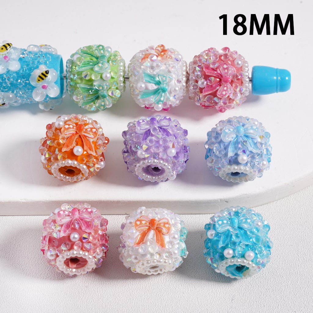 Assorted colorful beads with decorative elements on a white background, labeled '18MM'.