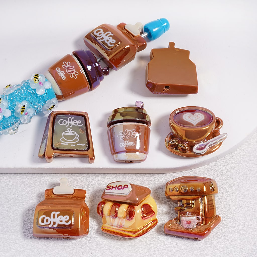 Set of miniature coffee-themed items including bottles, a cup, and a machine on a white background.
