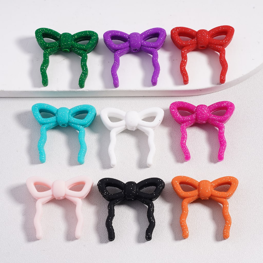 Colorful bow-shaped hair accessories on a white background