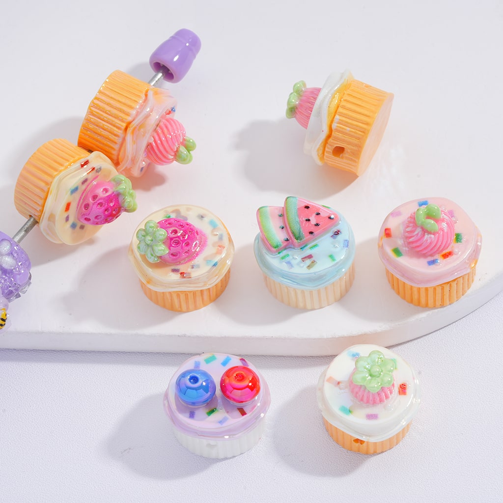 Colorful cupcake-shaped hair accessories on a white background