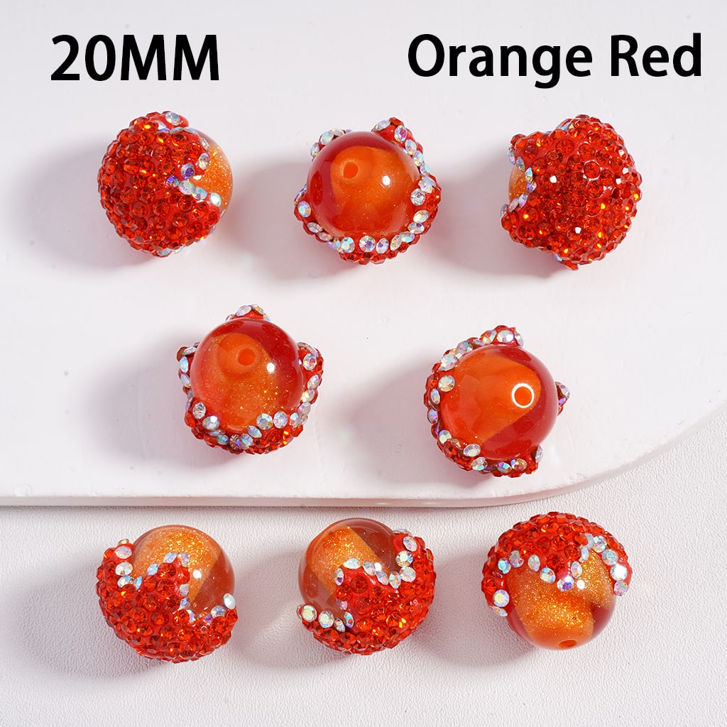 Orange red beads with silver accents on a white background