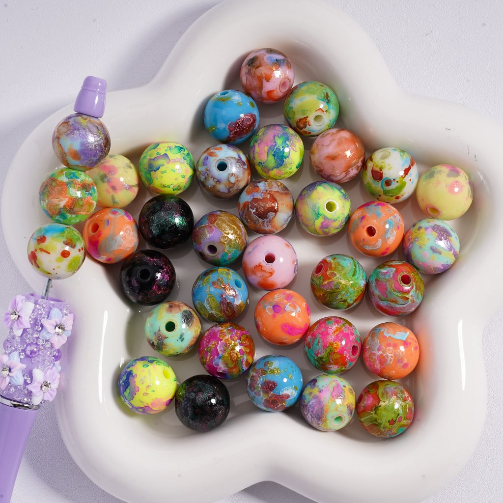 Assorted colorful beads on a white heart-shaped dish
