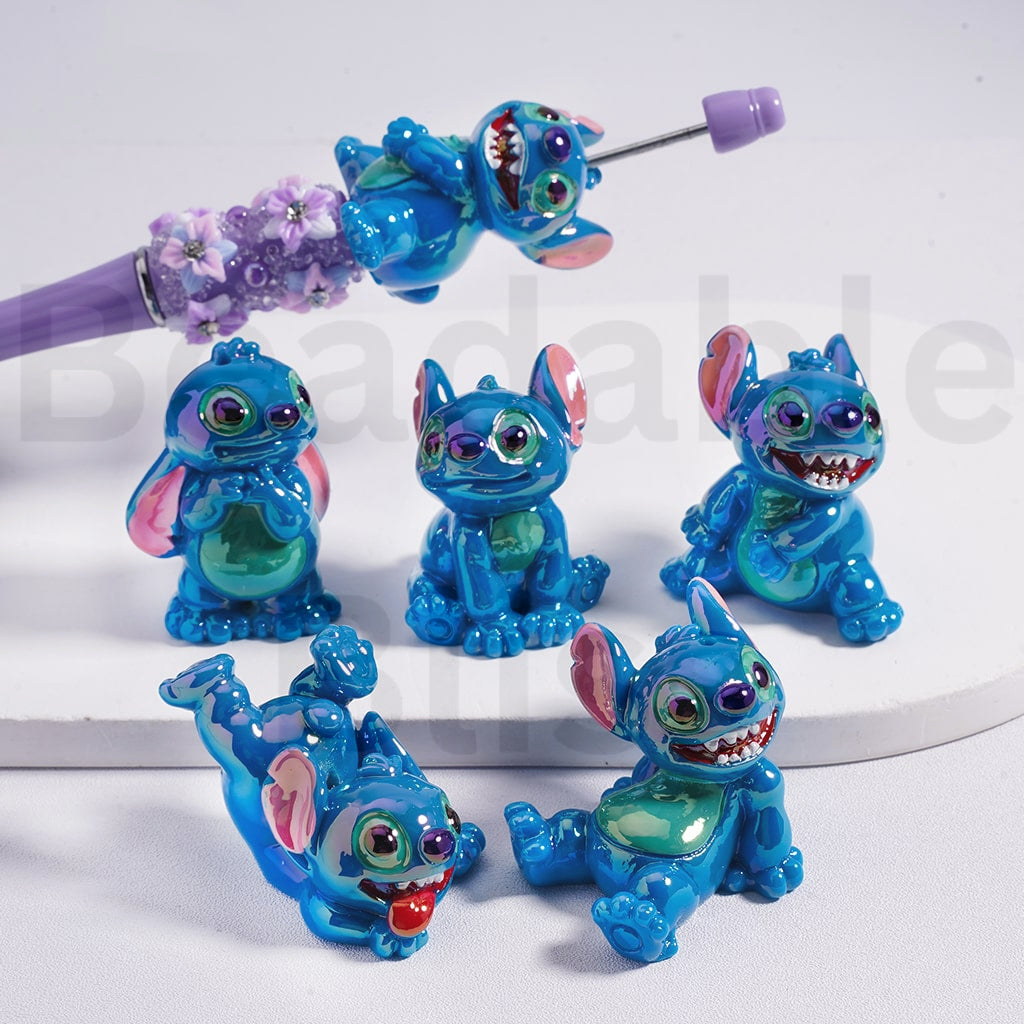Set of blue animated character earrings on a white background