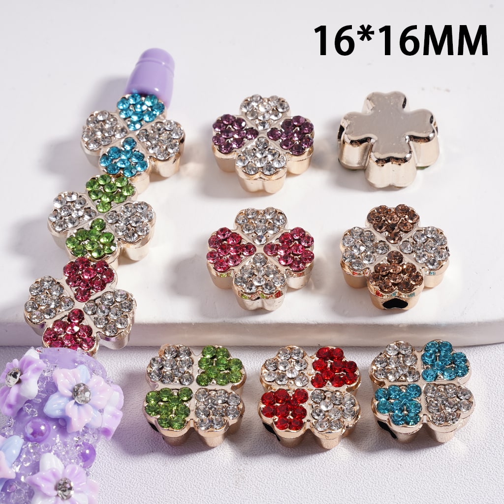 Colorful flower-shaped beads with rhinestones on a white background