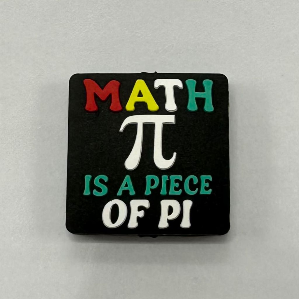 A black silicone bead with multicolor text that reads 'MATH π IS A PIECE OF PI'.