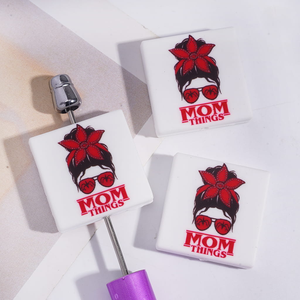 Girl Wearing Glasses Red Flower Headband with Text "MOM THINGS" Flat Square Shape Silicone Focal Beads