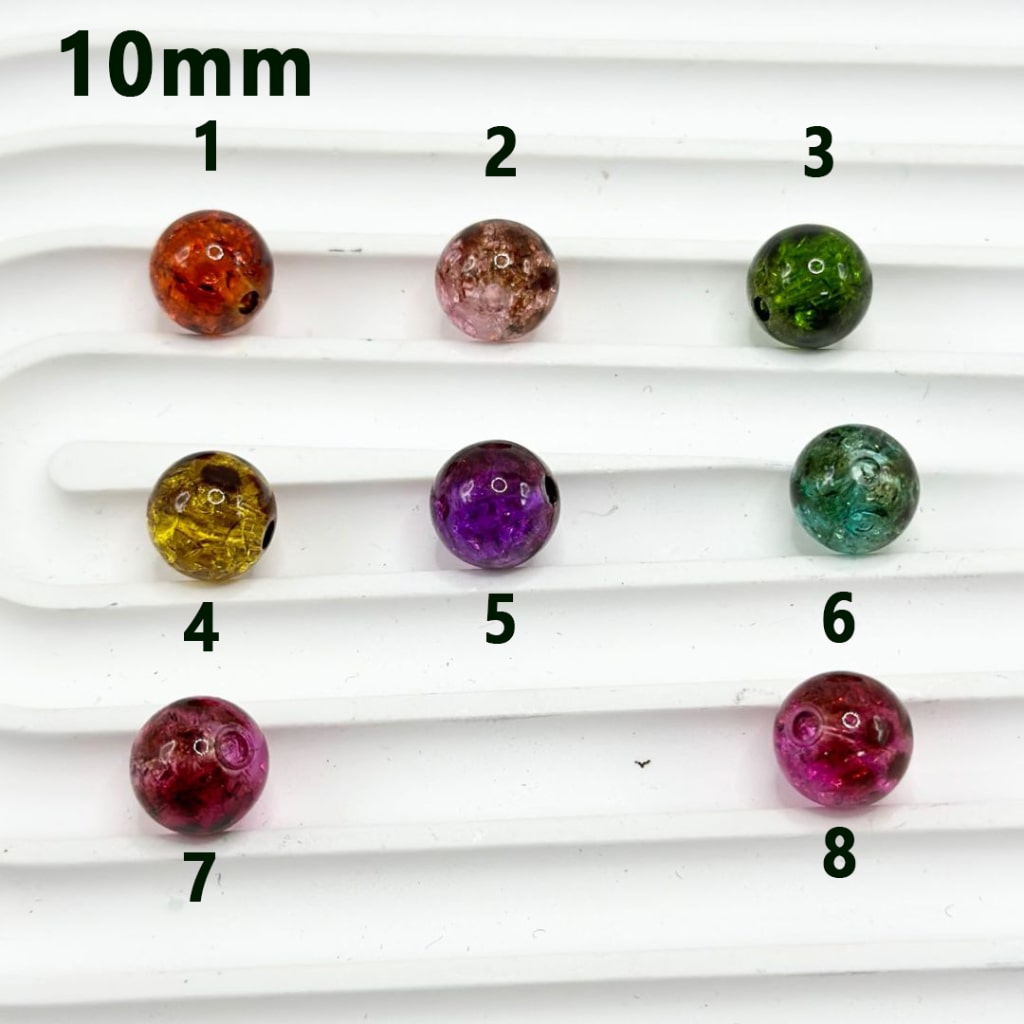 Assorted colored beads on a white background with labels indicating size and color.