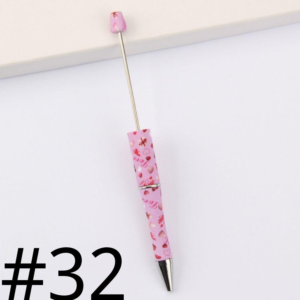 Pink pen with floral design on a white background