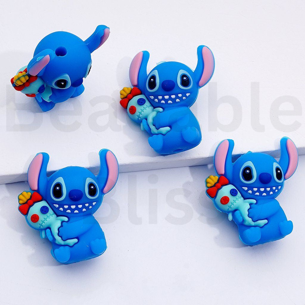 Four blue cartoon character figurines with colorful accessories on a white background