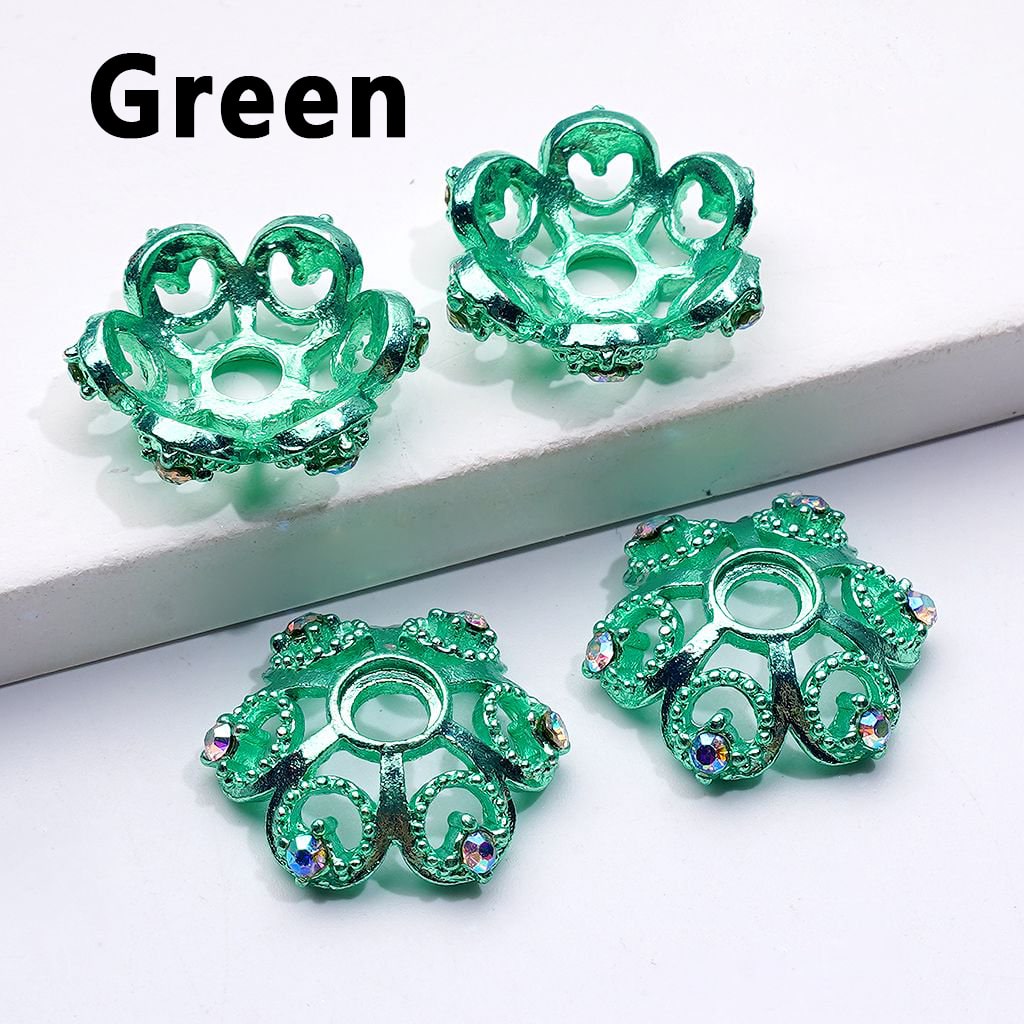 Green decorative items with intricate designs on a white surface

