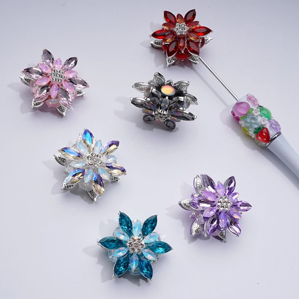 A collection of silver alloy six-petaled flowers with clear and colorful rhinestones and clay beads.

