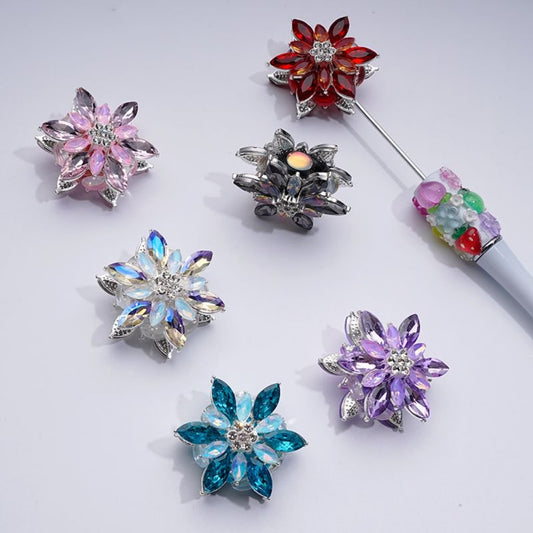 A collection of silver alloy six-petaled flowers with clear and colorful rhinestones and clay beads.

