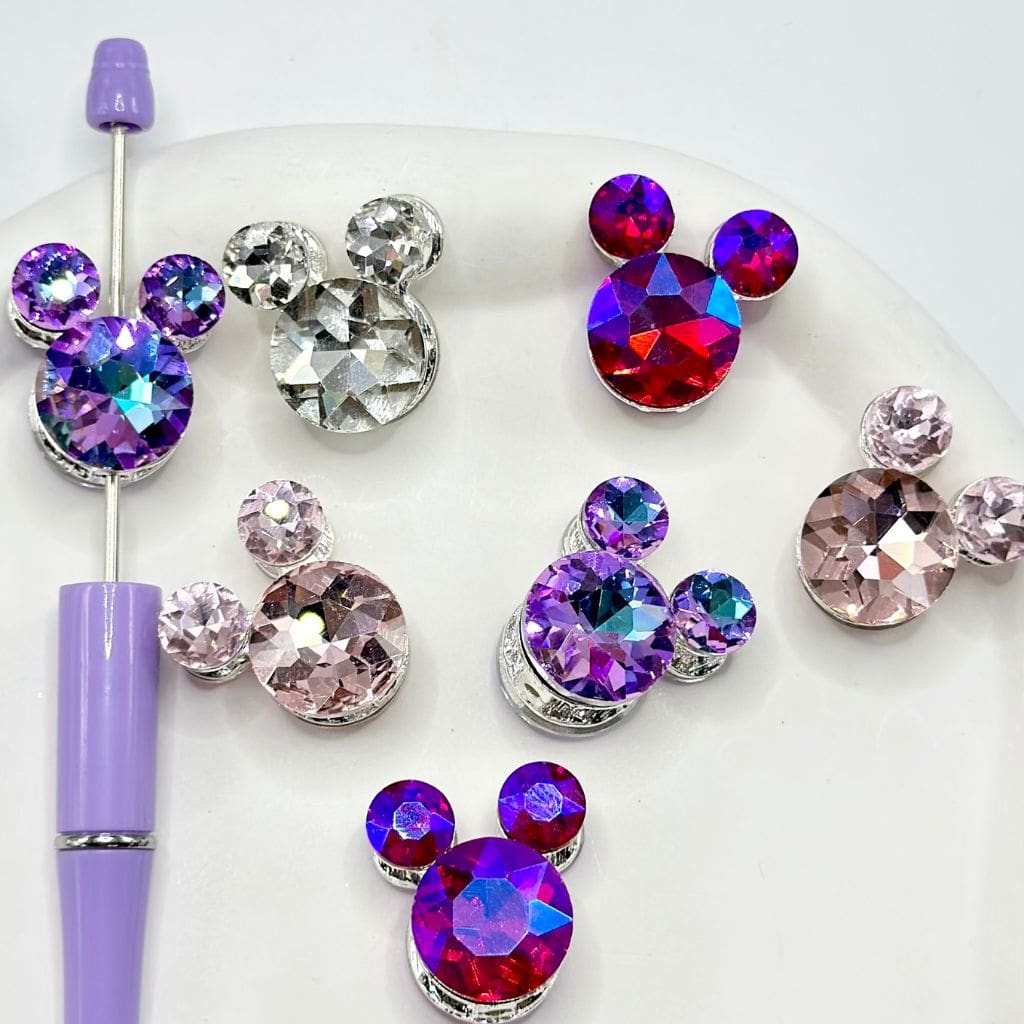 Colorful crystal Mickey Mouse earrings on a white background

