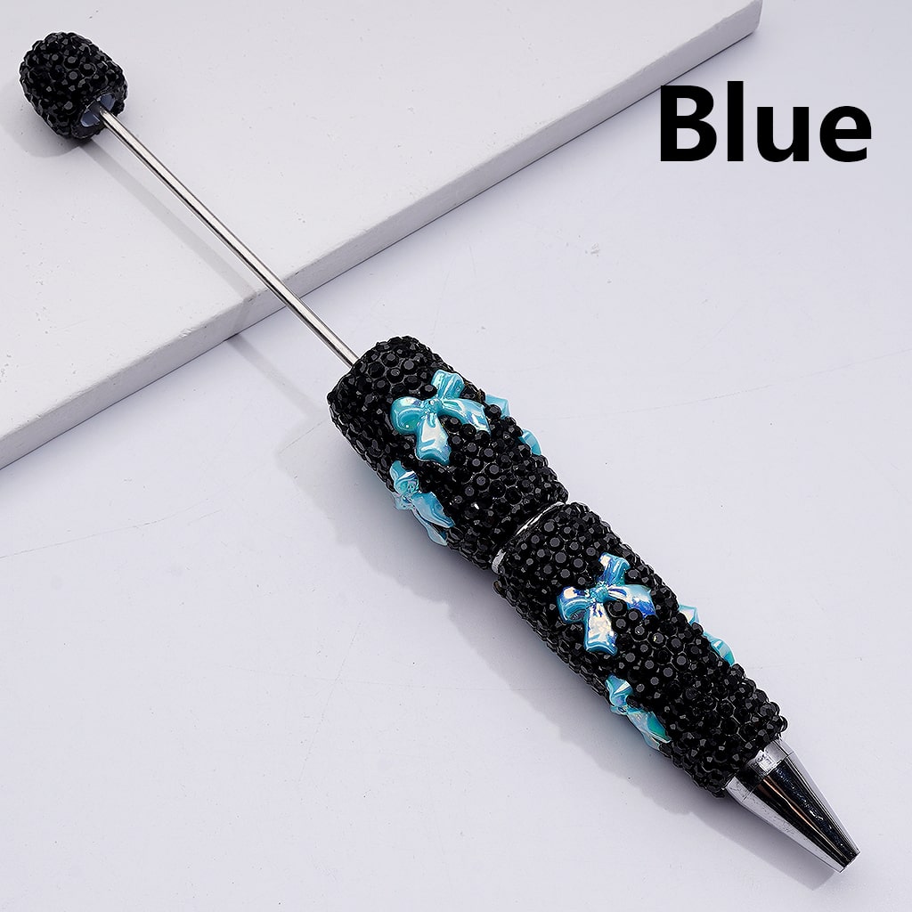 Decorative pen with black and blue bead design on a white background

