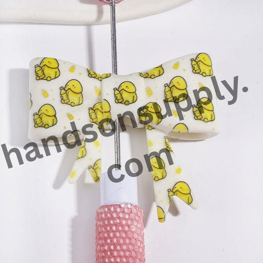 UV-Printed Cheerful Yellow Man Exclusive with Drink Bottle Design Soft Bowtie Shape Silicone Focal Beads, 53*59MM