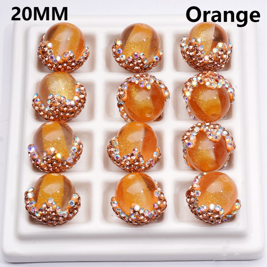 Orange gemstones with rose gold accents on a white tray, labeled '20MM' and 'Orange'.