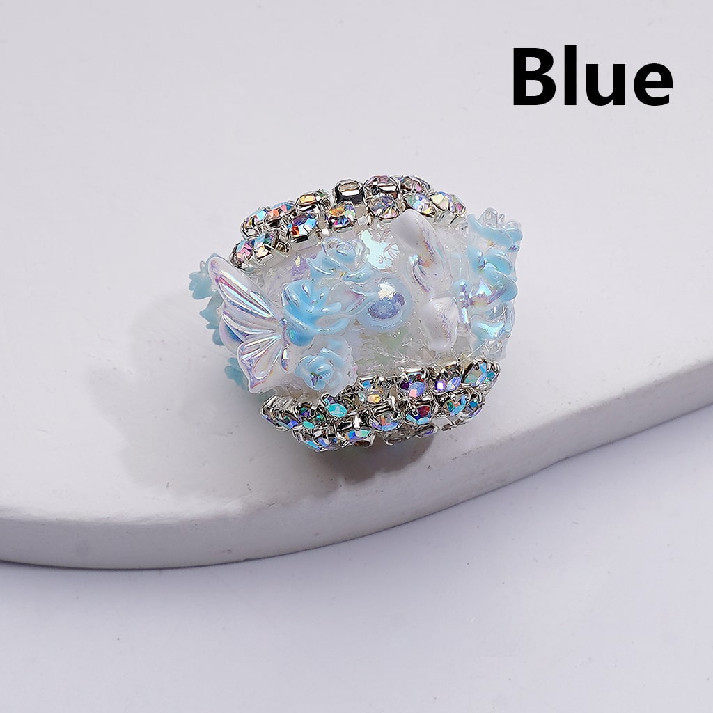 Decorative hair tie with floral design and blue color on a white background

