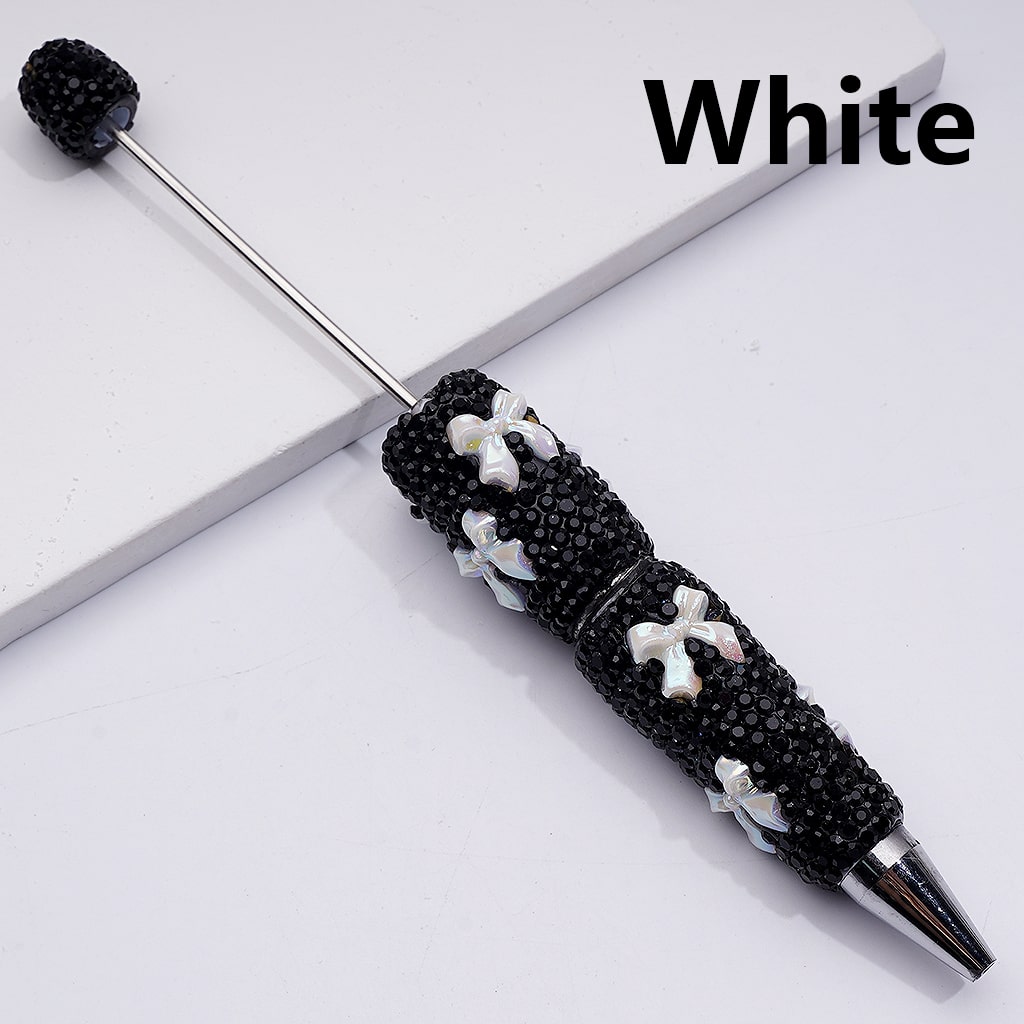 Decorative pen with black embellishments and white flowers on a white background

