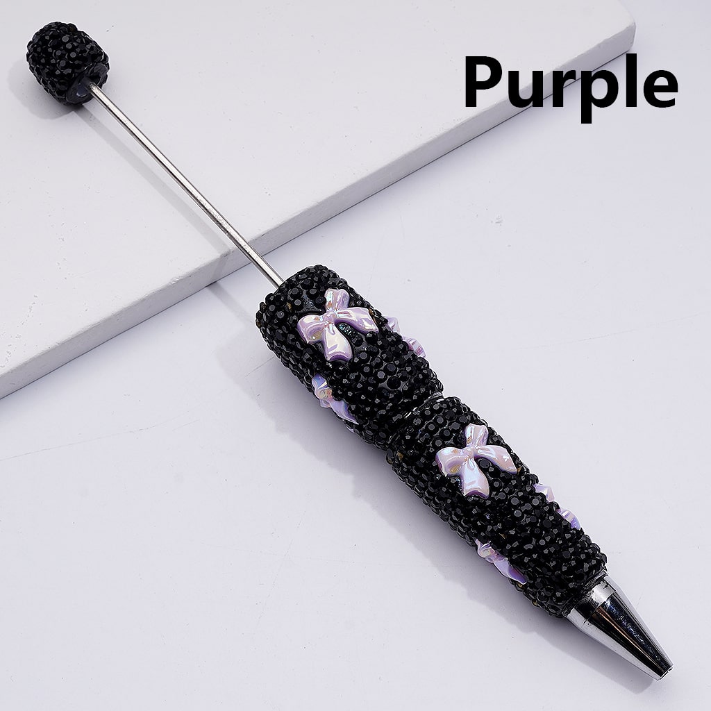 Decorative pen with black beads and purple accents on a white surface, labeled 'Purple'.


