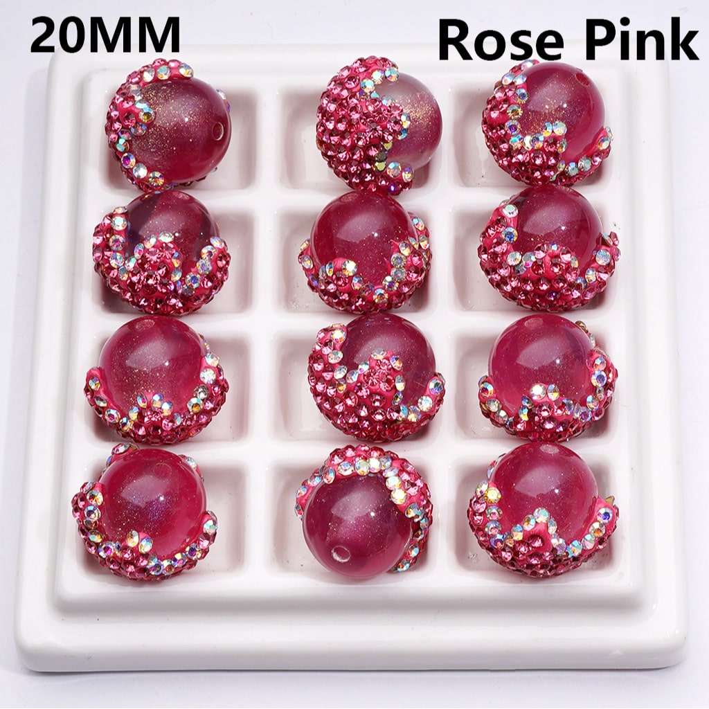 Rose pink beads with rhinestones on a white tray, labeled '20MM' and 'Rose Pink'.