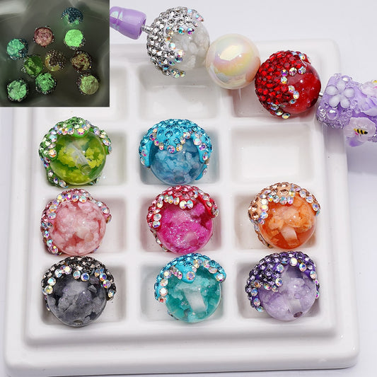 Colorful crystal-like beads with rhinestones on a white tray

