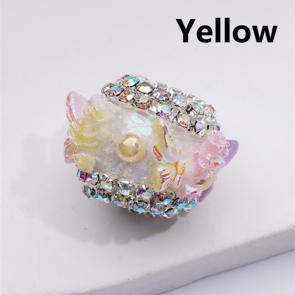 Decorative ring with floral design and rhinestones on a white background

