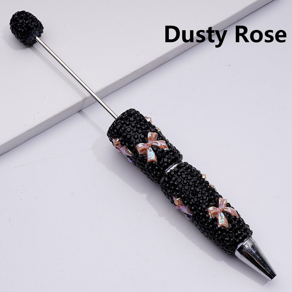 Decorative pen with black gemstones and pink bows on a white background, labeled 'Dusty Rose'.

