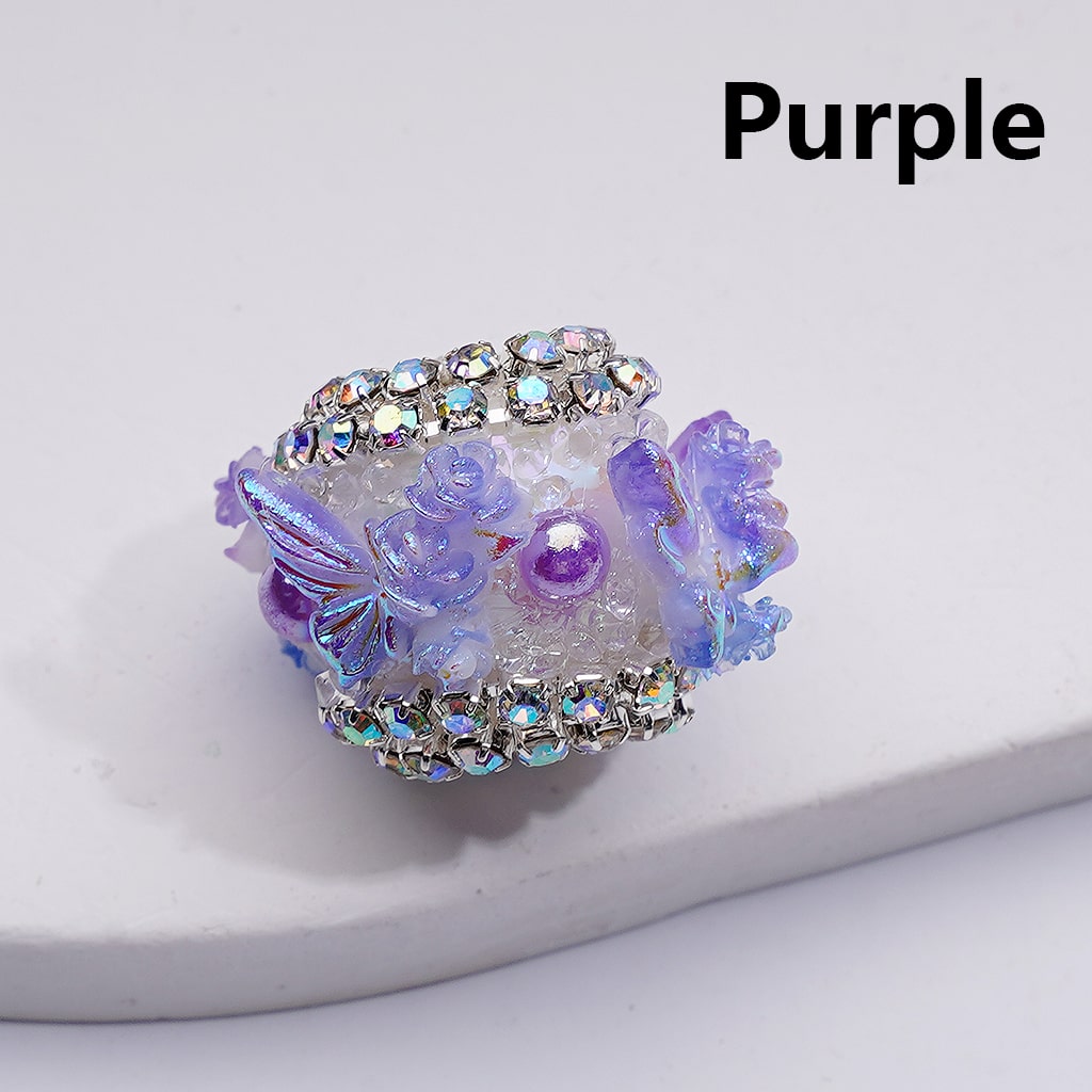 Decorative purple item with crystals on a white background

