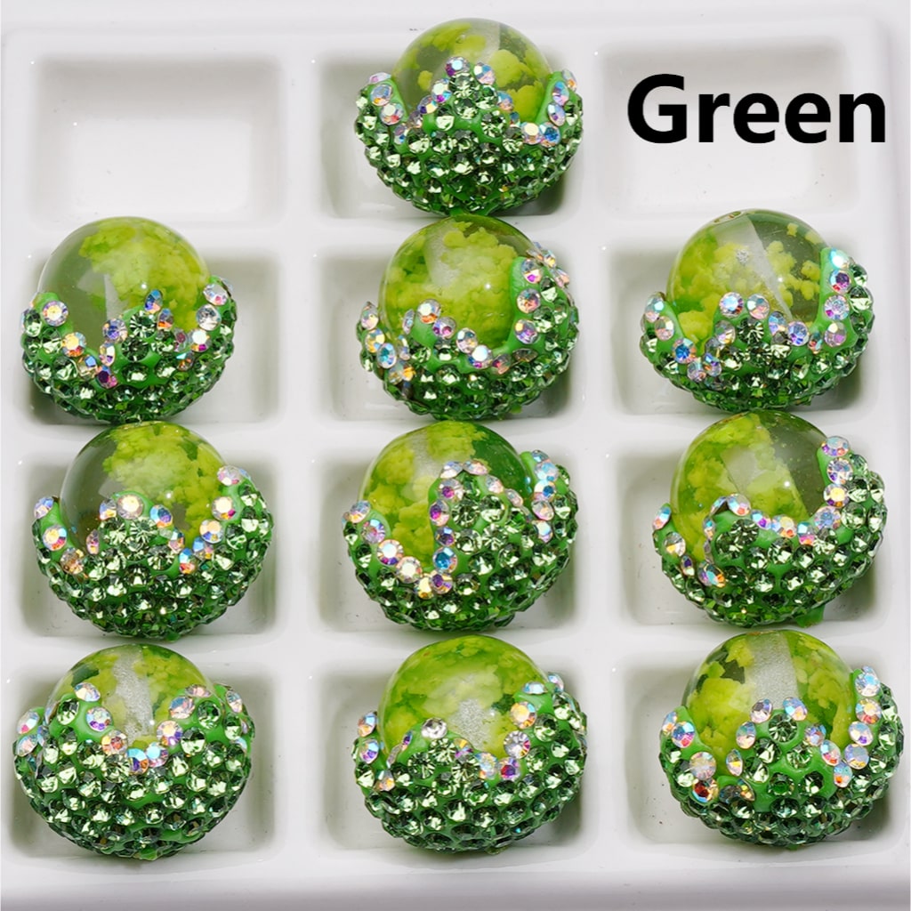 Green decorative items with rhinestones arranged in a grid on a white background.

