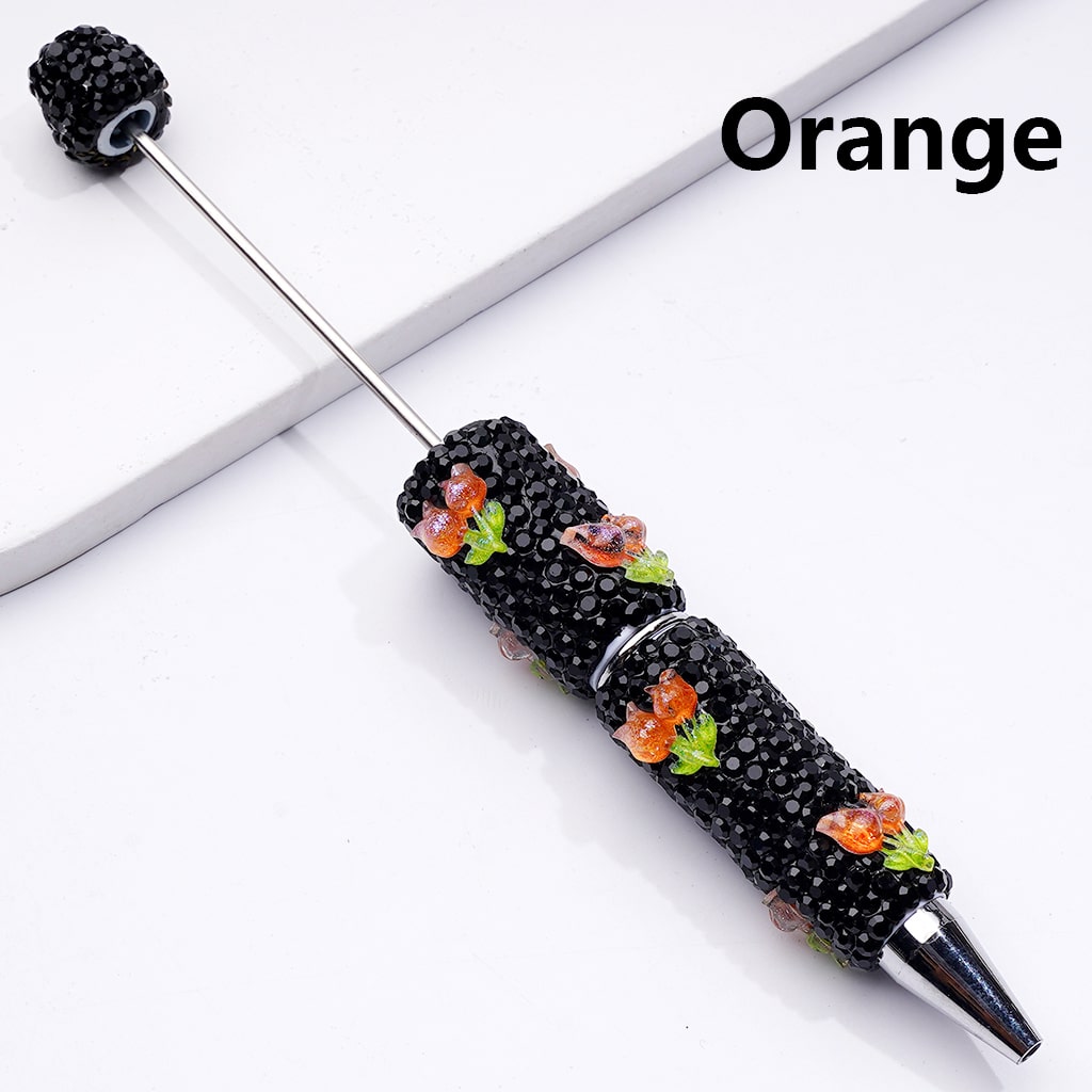 Decorative pen with black beads and orange flowers on a white background

