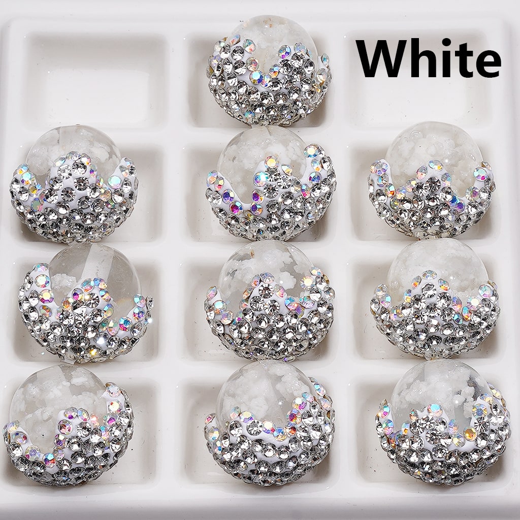 Clear spherical objects with silver and multicolor glittery embellishments on a white background.

