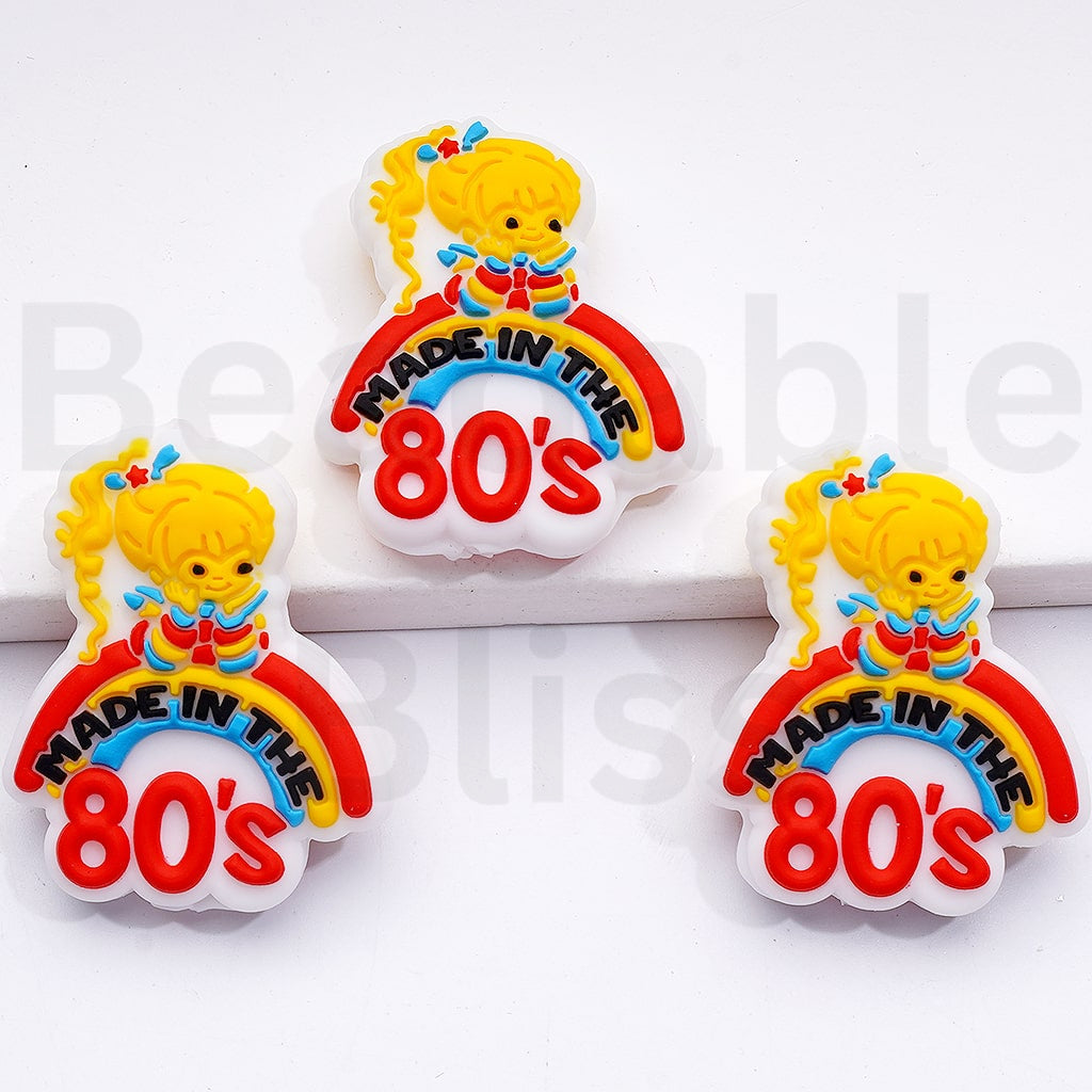 Three 'Made in the 80s' themed pins with a cartoon character on a white background.

