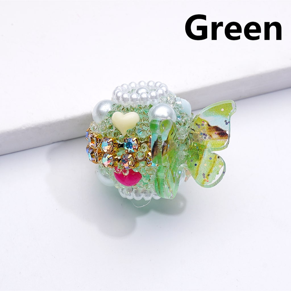 Decorative item with butterfly design and colorful embellishments on a white background

