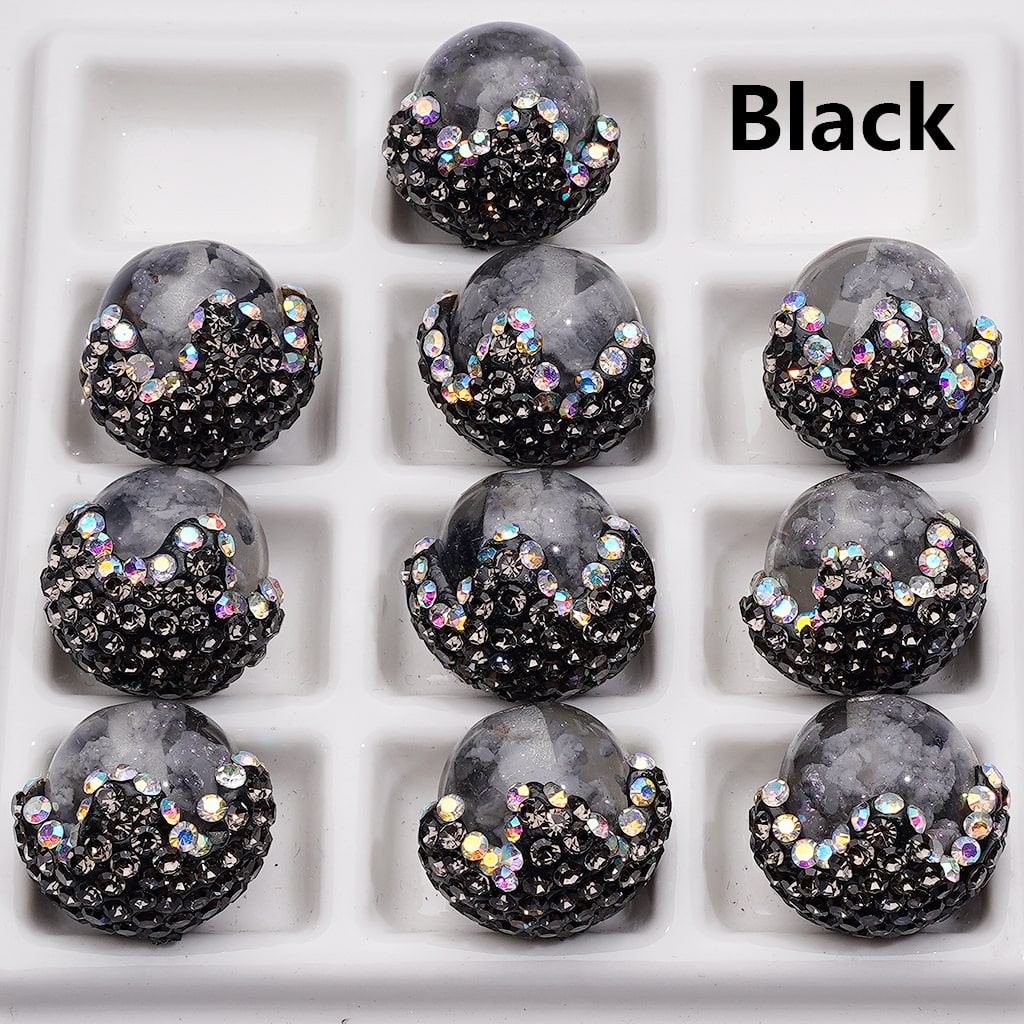 Black and gray embellished buttons on a white background with 'Black' text.

