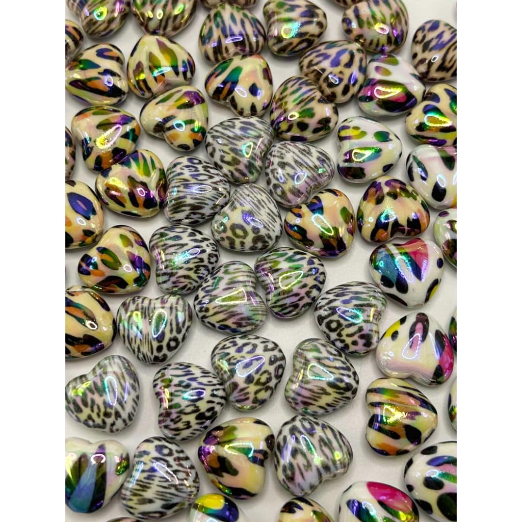 Colorful heart-shaped beads with leopard print pattern on a white background

