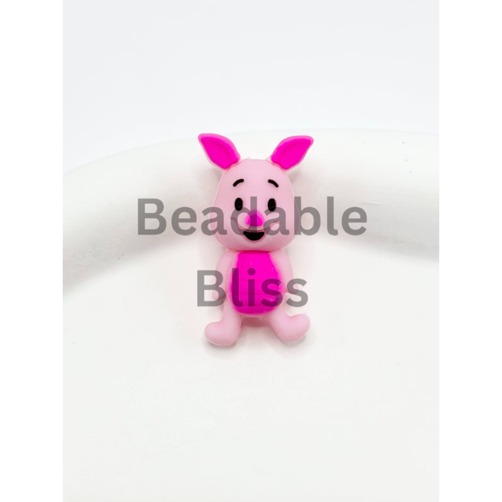 Pink cartoon character figurine on a white background

