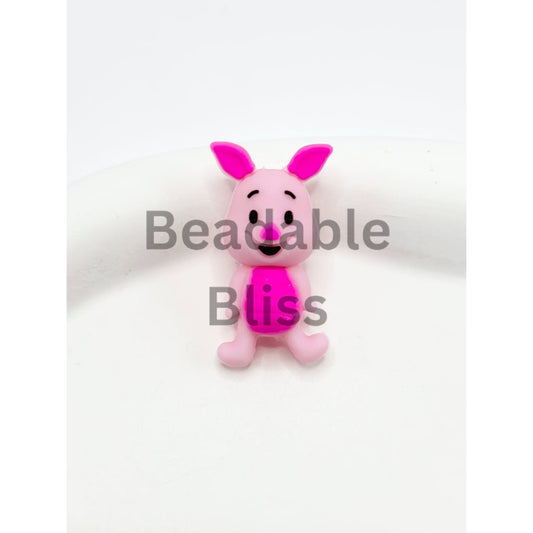 Pink cartoon character figurine on a white background


