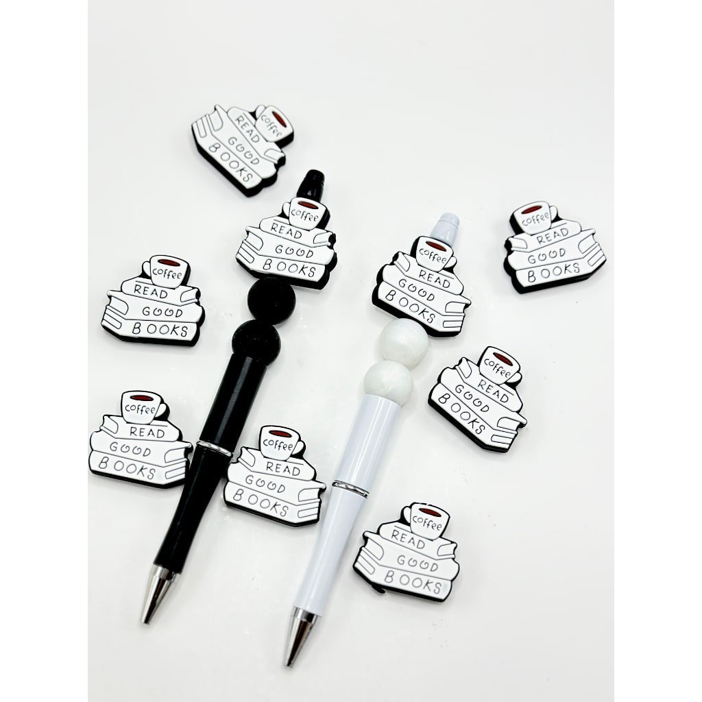 Silicone beads shaped like books with a phrase about reading on them, displayed alongside pens with the same design.