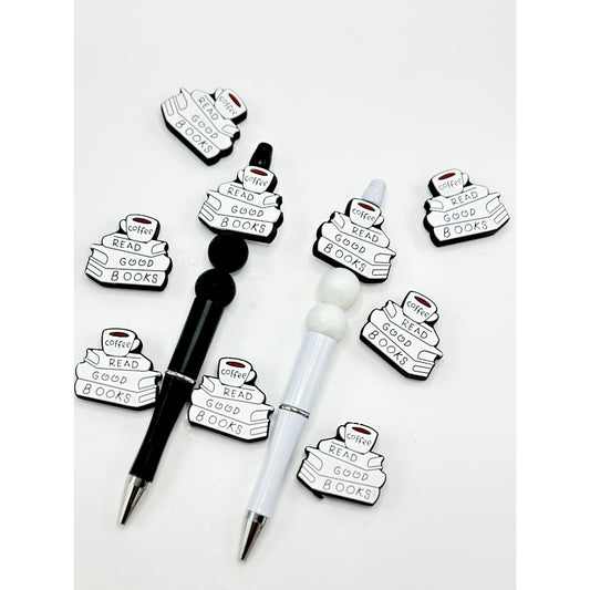 Silicone beads shaped like books with a phrase about reading on them, displayed alongside pens with the same design.