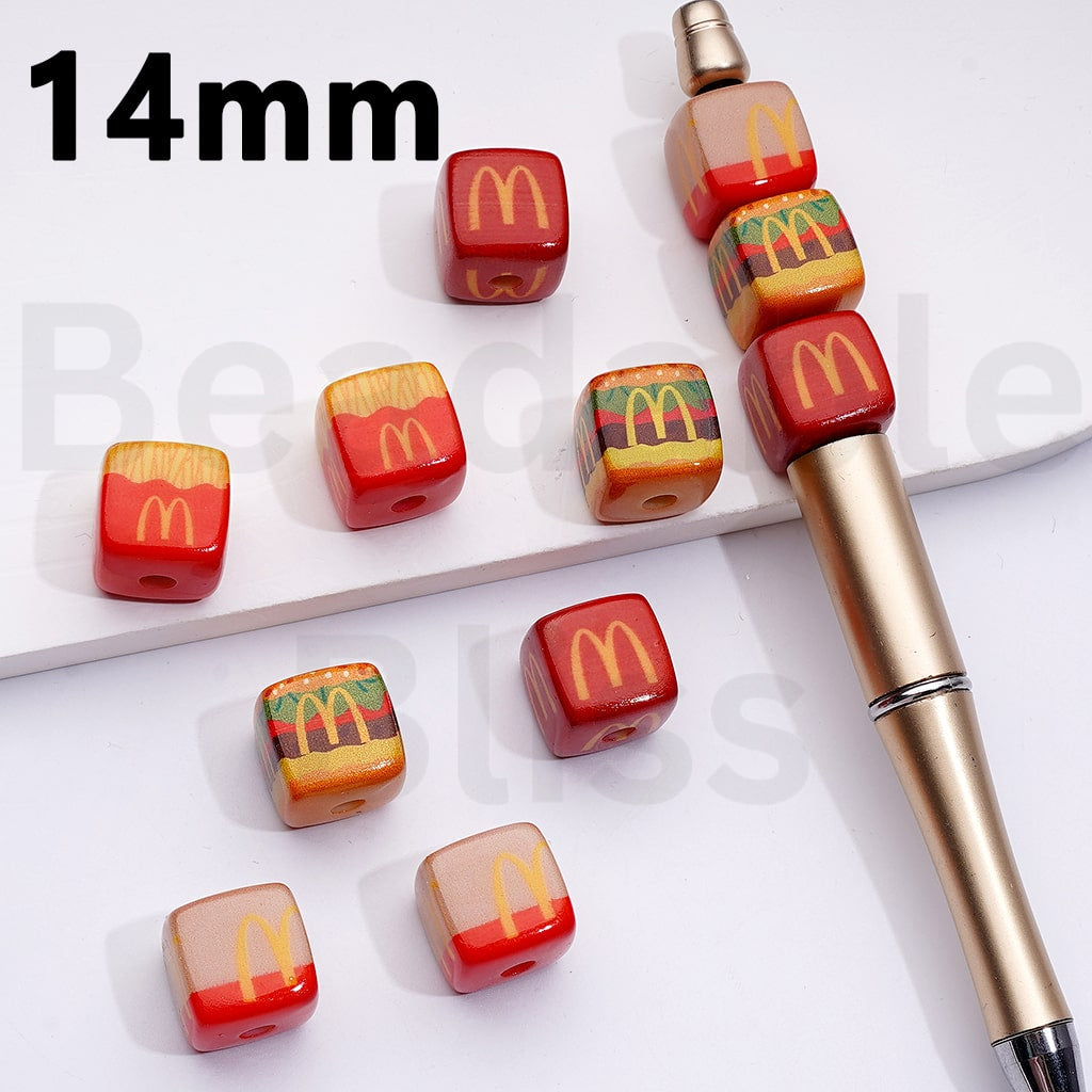 Set of McDonald's-themed beads and a pen on a white background

